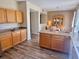 Well-lit kitchen features wood cabinets, an island, and wood-look flooring, with dining area at 525 Aster Dr, Davenport, FL 33897