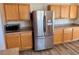 Kitchen with wood cabinets and stainless steel refrigerator, plus a microwave on the counter at 525 Aster Dr, Davenport, FL 33897