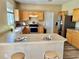 Well-equipped kitchen with stainless steel appliances, breakfast bar, and laminate flooring at 525 Aster Dr, Davenport, FL 33897