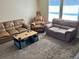 Cozy living room with plush carpet, multiple seating options, and lots of natural light at 525 Aster Dr, Davenport, FL 33897