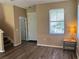 Bright living room with wood-look flooring, a window, and a neutral color scheme at 525 Aster Dr, Davenport, FL 33897
