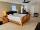 Spacious main bedroom featuring a comfortable bed, a ceiling fan, and ample natural light at 525 Aster Dr, Davenport, FL 33897