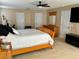 Bright main bedroom with wood furniture, featuring multiple closets and a ceiling fan at 525 Aster Dr, Davenport, FL 33897
