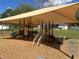Community playground with shade, slides, climbing structures, and safety signage for children at 525 Aster Dr, Davenport, FL 33897