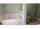 Bathroom with a soaking tub, tiled floors, toilet and shower, creating a relaxing, spa-like atmosphere at 5610 Forest Ridge Dr, Winter Haven, FL 33881