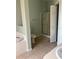 Bathroom featuring a soaking tub, glass shower, toilet, and tiled floors, offering a spa-like retreat at 5610 Forest Ridge Dr, Winter Haven, FL 33881
