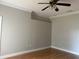 Bedroom with hardwood floors, a ceiling fan, neutral walls, and an abundance of natural light at 5610 Forest Ridge Dr, Winter Haven, FL 33881