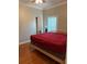 Main bedroom with king-size bed and wood floors at 5610 Forest Ridge Dr, Winter Haven, FL 33881