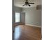Bedroom with hardwood floors, a ceiling fan, neutral walls, and natural light from the window at 5610 Forest Ridge Dr, Winter Haven, FL 33881