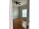 Bright bedroom featuring hardwood floors, a ceiling fan, and natural light from a window at 5610 Forest Ridge Dr, Winter Haven, FL 33881