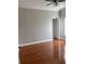 A light-filled bedroom featuring hardwood floors, ceiling fan, and closet at 5610 Forest Ridge Dr, Winter Haven, FL 33881
