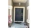 A close-up of the front door area, showing the exterior door and trimmed columns at 5610 Forest Ridge Dr, Winter Haven, FL 33881