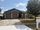 Charming single-story home with a well-maintained lawn, two-car garage, and inviting front entrance at 5610 Forest Ridge Dr, Winter Haven, FL 33881