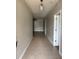 Inviting hallway with tile flooring leading to a living area, showcasing an open and airy layout at 5610 Forest Ridge Dr, Winter Haven, FL 33881