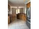 Kitchen view featuring stainless steel appliances, and wood cabinets overlooking eat-in area at 5610 Forest Ridge Dr, Winter Haven, FL 33881