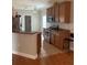 Well-lit kitchen featuring stainless appliances, wood cabinets, and a breakfast bar at 5610 Forest Ridge Dr, Winter Haven, FL 33881