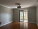Bright living room featuring hardwood floors and sliding glass door to lanai at 5610 Forest Ridge Dr, Winter Haven, FL 33881