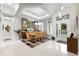 Elegant dining room with a glass table and modern light fixtures at 6001 Caymus Loop, Windermere, FL 34786