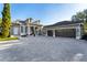 Two-story house with a three-car garage and paver driveway at 6001 Caymus Loop, Windermere, FL 34786