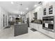 Modern kitchen with large island, stainless steel appliances, and granite countertops at 6001 Caymus Loop, Windermere, FL 34786