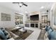 Spacious living room with comfortable seating, fireplace, and large TV at 6001 Caymus Loop, Windermere, FL 34786