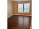 Bedroom with dark wood-look vinyl flooring and window blinds at 6088 Westgate Dr # 103, Orlando, FL 32835