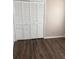 Bedroom with spacious closet and wood-look flooring at 6088 Westgate Dr # 103, Orlando, FL 32835