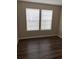 Bright bedroom with two windows and wood-look flooring at 6088 Westgate Dr # 103, Orlando, FL 32835