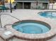 Clean and modern hot tub with a surrounding brick patio at 6088 Westgate Dr # 103, Orlando, FL 32835