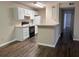 Updated kitchen features a breakfast bar and black appliances at 6088 Westgate Dr # 103, Orlando, FL 32835