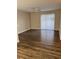Bright living room with wood floors, ceiling fan, and sliding glass door at 6088 Westgate Dr # 103, Orlando, FL 32835