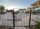 Gated entrance to the community swimming pool, clearly marked with rules at 6088 Westgate Dr # 103, Orlando, FL 32835