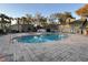 Community pool and spa with surrounding patio at 6088 Westgate Dr # 103, Orlando, FL 32835