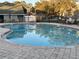 Inviting kidney-shaped swimming pool with surrounding lounge chairs at 6088 Westgate Dr # 103, Orlando, FL 32835