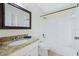 Bathroom featuring granite countertops, a large mirror, and a tub/shower combo at 686 Roaring Dr # 343, Altamonte Springs, FL 32714