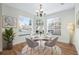 Cozy dining room featuring a modern chandelier, natural lighting, and stylish furnishings at 686 Roaring Dr # 343, Altamonte Springs, FL 32714