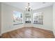 Bright dining room features wood flooring, a chandelier, and three large windows at 686 Roaring Dr # 343, Altamonte Springs, FL 32714
