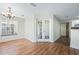 Dining room has a chandelier, wood floors, and French doors leading to another area at 686 Roaring Dr # 343, Altamonte Springs, FL 32714