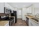 Efficient kitchen featuring white cabinets, stainless steel appliances, and granite countertops at 686 Roaring Dr # 343, Altamonte Springs, FL 32714