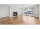 Bright living room featuring a cozy fireplace, hardwood floors, and abundant natural light from large windows at 686 Roaring Dr # 343, Altamonte Springs, FL 32714