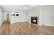 Open living area with a fireplace, hardwood floors, and a view of the kitchen with granite countertops at 686 Roaring Dr # 343, Altamonte Springs, FL 32714