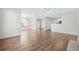 Open-concept living room with wood floors flowing into the dining area and kitchen at 686 Roaring Dr # 343, Altamonte Springs, FL 32714