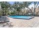 This inviting community pool is surrounded by mature trees, lounge chairs, and a well maintained brick surround at 686 Roaring Dr # 343, Altamonte Springs, FL 32714