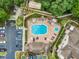 Aerial view of a community pool area with lounge chairs, umbrellas, and a hot tub at 686 Roaring Dr # 343, Altamonte Springs, FL 32714