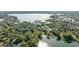 An aerial view of a lakeside community with mature trees, a lake and a condo complex at 690 Osceola Ave # 604, Winter Park, FL 32789