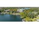 A lakeside community with lake access and docks, lush greenery, and a multi-story condominium at 690 Osceola Ave # 604, Winter Park, FL 32789