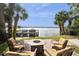 Outdoor seating area with a fire pit and serene water view, perfect for relaxing and entertaining guests at 690 Osceola Ave # 604, Winter Park, FL 32789