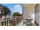 Relaxing balcony featuring a stone top table, views of lush trees, and glimpses of a serene lake at 690 Osceola Ave # 604, Winter Park, FL 32789