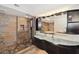 Sleek bathroom featuring unique dual sinks, stone-tiled walls and floors, and modern shower fixtures at 690 Osceola Ave # 604, Winter Park, FL 32789