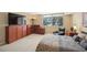 Spacious bedroom featuring large window, wood cabinets, flat screen TV, and a comfortable chair at 690 Osceola Ave # 604, Winter Park, FL 32789